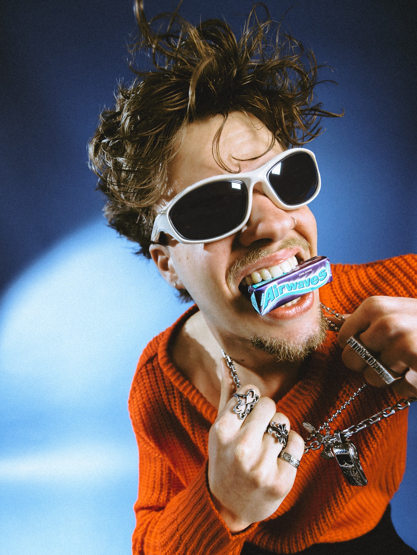 Creator biting into an Airwaves gum pack on camera, part of 1Table's social-native content for the brand.